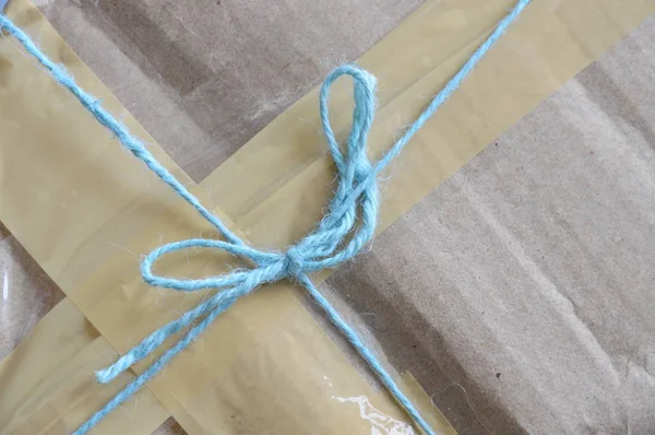 Parcel rope tying around brown postal box — Stock Photo, Image