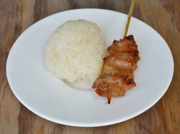 Pečené vepřové na dřevěnou hůl jíst s lepkavá rýže na jídlo — Stock fotografie
