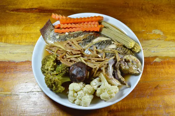 Риба манго на пару зі скибочкою імбиру та овочами в соєвому соусі на блюді — стокове фото