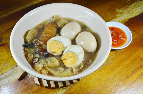 Braised fish maw in red gravy topping boiled egg and spicy chili sauce — Stock Photo, Image