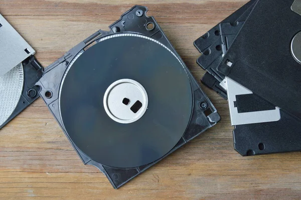 crack floppy disk on wooden board