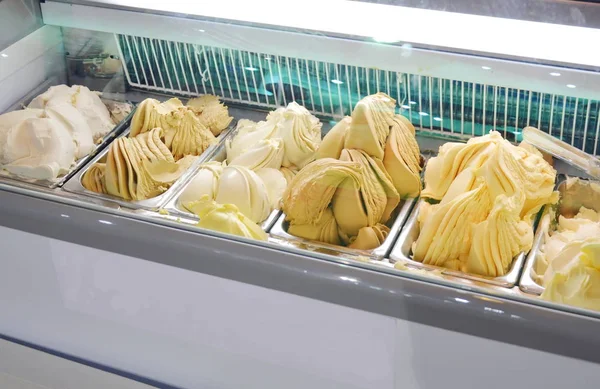 Gelato italiano sorvete misturado creme e frutas na caixa no armário de congelador elétrico — Fotografia de Stock