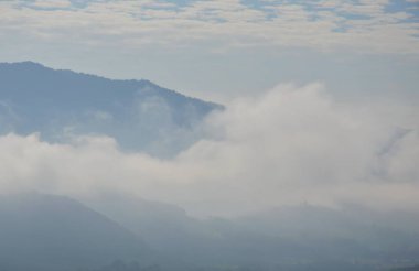Bulutlu ve güneşli bir günde kapak dağ yüzen sis
