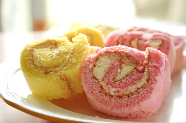 Mini strawberry and vanilla jam roll on dish — Stock Photo, Image