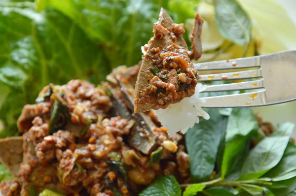 Spicy minced pork and liver salad with sticky rice stab in fork — Stock Photo, Image