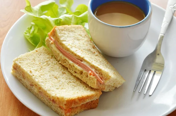 Schweinefleisch Bologna Vollkorn-Sandwich mit frischer grüner Eiche und Kaffee auf Teller — Stockfoto