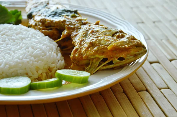 boiled mackerel in spicy turmeric sauce eat couple with rice and vegetable