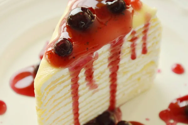 Crape cake dressing blueberry sauce on dish — Stock Photo, Image