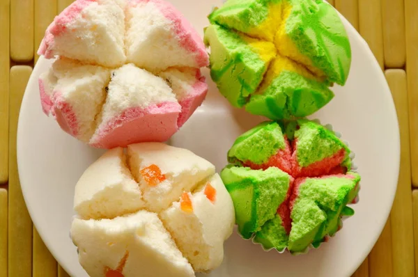 Assorted colorful cotton cupcake in paper on plate — Stock Photo, Image