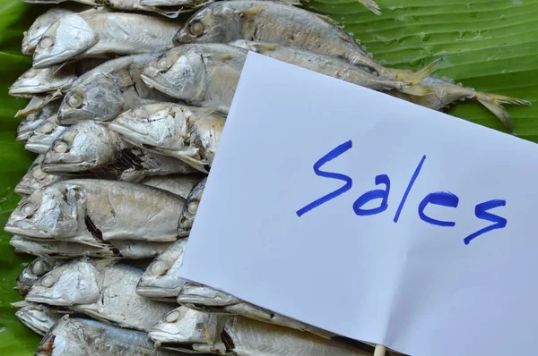 boiled mackerel on fresh banana leaf for sale in market