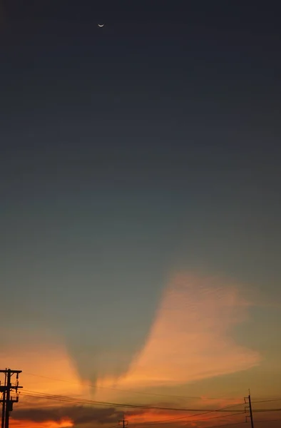 Half moon on twilight sky in sunset — Stock Photo, Image