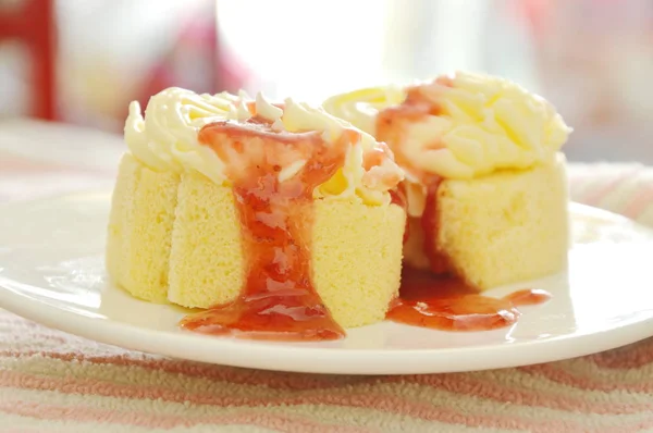 Butter cake roll topping vanilla cream dressing strawberry sauce on plate — Stock Photo, Image