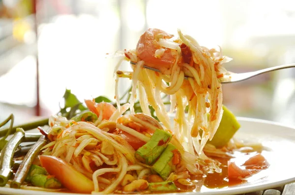 Somtum Thai green papaya salad tasted spicy sour and sweet on fork — Stock Photo, Image