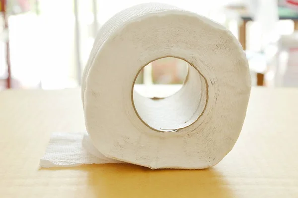 White tissue paper rolling on brown hard sheet board — Stock Photo, Image