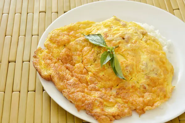 Crispy egg omelet stuffed minced pork topping basil leaf on rice — Stock Photo, Image