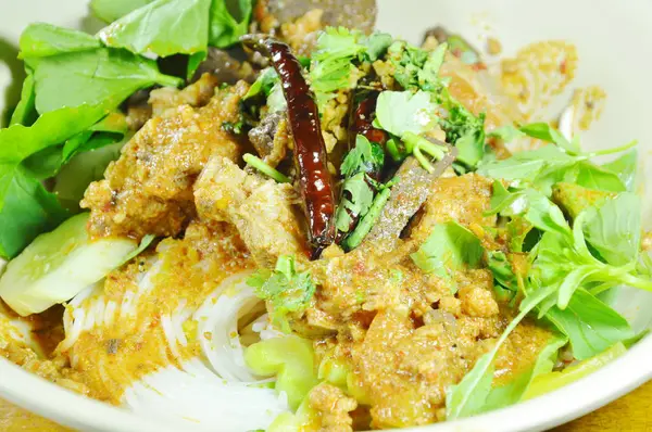 Rice noodles dressing spicy chop pork and bone red cotton tree sauce with vegetable on bowl — Stock Photo, Image