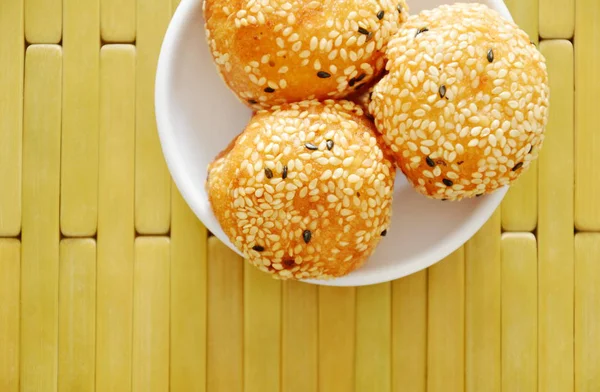 Fried glutinous ball topping sesame filled mushed yellow bean on cup — Stock Photo, Image