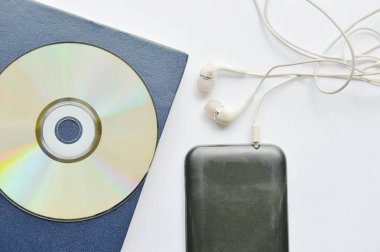  Beyaz arka plan üzerinde smartphone içinde kitap ve kulaklık bağlamak