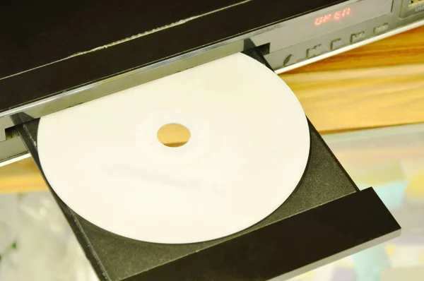 DVD put on insert disc player in wooden cupboard — Stock Photo, Image