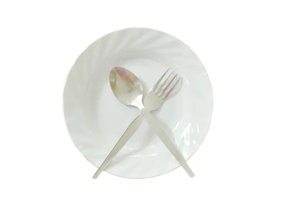 Spoon and fork crossing on dish in white background — Stock Photo, Image