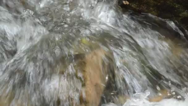 Вода течет по скале и брызги волн в реке — стоковое видео