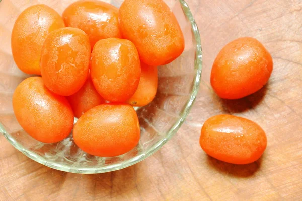 stock image  cherry tomatoes in glass cup on table