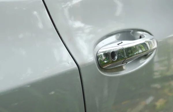 Silver car front door handle with keyhole in parking — Stock Photo, Image