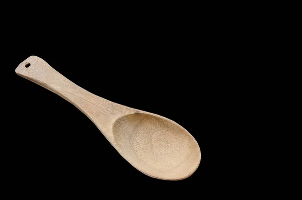 Wooden scoop on black background — Stock Photo, Image