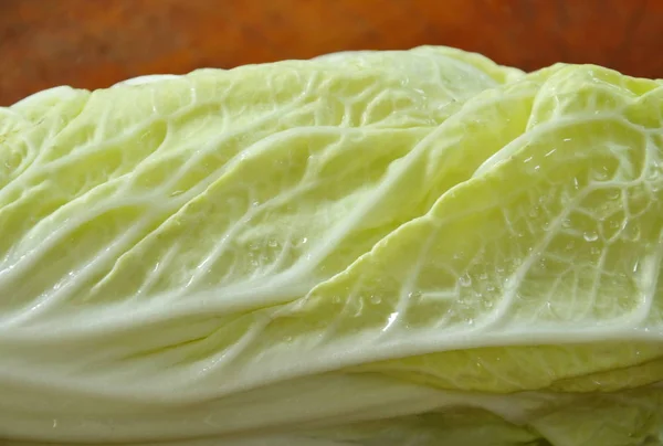 Fresh Chinese cabbage with drop of water on wooden chop block — Stock Photo, Image
