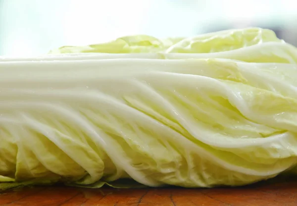 Chou chinois frais avec goutte d'eau sur planche à découper en bois — Photo