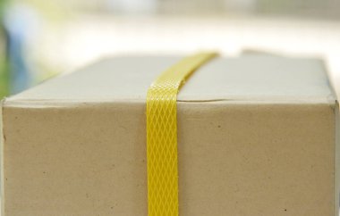  sarı plastik bant tarafından sarılmış kaş sert kağıt parsel