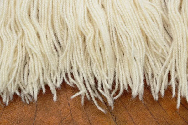 Knitting wool texture on wooden table — Stock Photo, Image