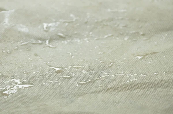 Goutte d'eau roulant sur sac en tissu artificiel — Photo