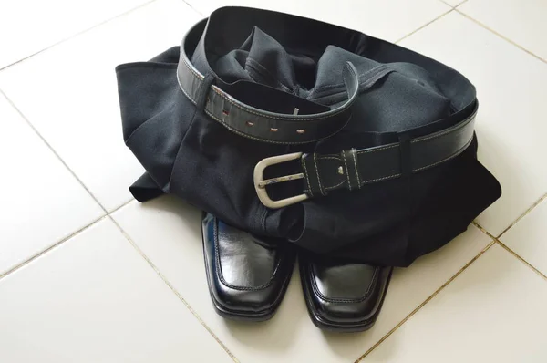 Black business pant and lather shoe on white tile floor — Stock Photo, Image