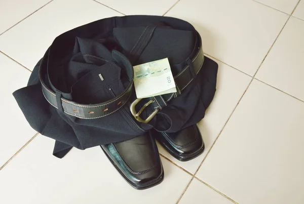 Banknote with black business pant and lather shoe on white tile floor — Stock Photo, Image