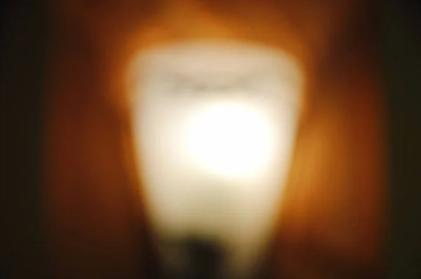 Blurry of electric lamp on building wall background and texture — Stock Photo, Image