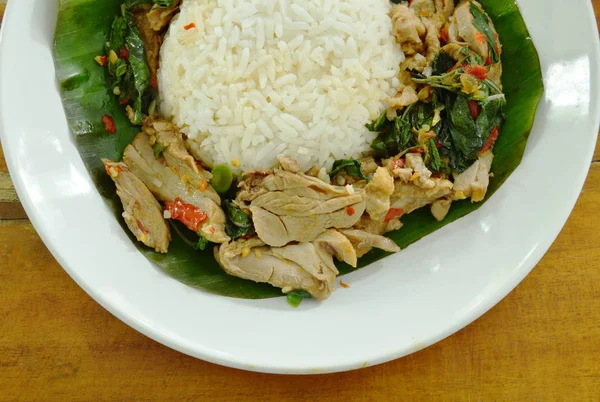 Spicy fried duck meat with basil leaf and rice on fresh banana leaf — Stock Photo, Image