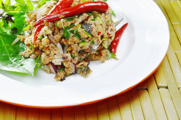 Spicy minced catfish with herb topping red chili Thai salad on plate — Stock Photo, Image
