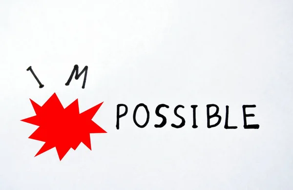 red bomb exploding impossible to possible words on white paper background