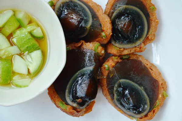 fried preserved egg wrapped fish cake dipping sweet sauce