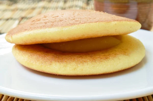 Dorayaki Japanese pancake stuffed sweet mashed bean on plate eat with tea cup