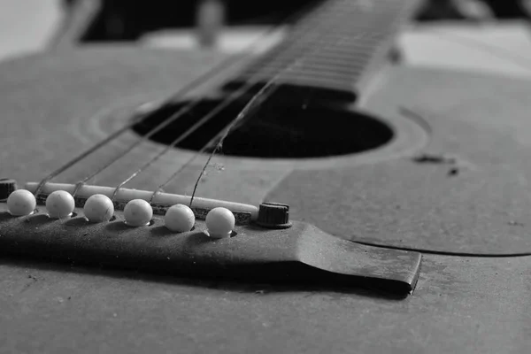 old guitar and broken string in home