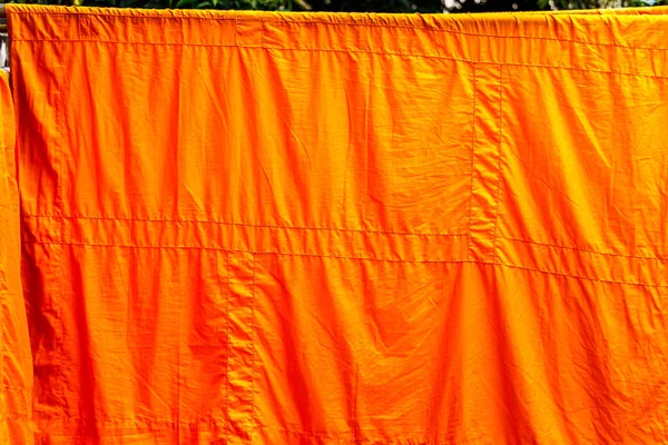 yellow monk cloth wash and dry on clothes line.