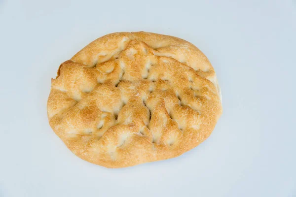 Loaf of bread on white table, food closeup. Top view — Stock Photo, Image