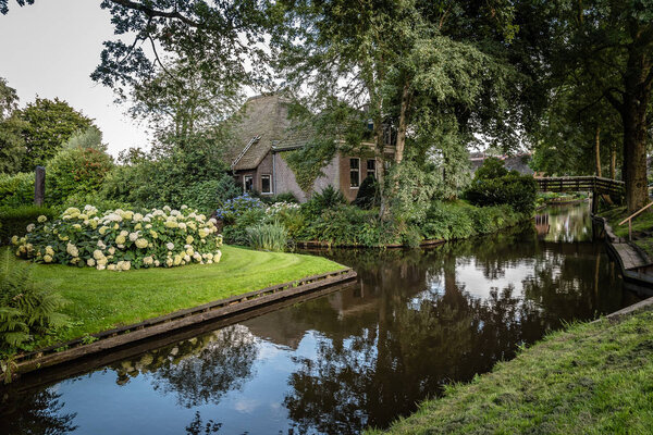 Waterway and cottage in village in the Netherlands