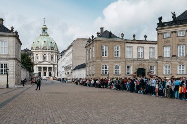 A crowd of tourists in waiting the changing guard in Amalienborg clipart
