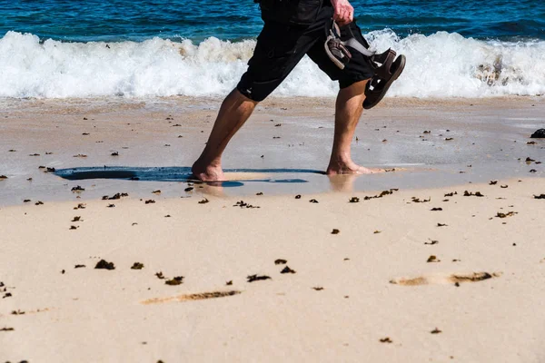 Sezione bassa di uomo che cammina a piedi nudi sulla spiaggia — Foto Stock