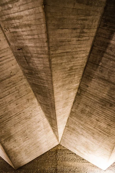 Illuminated concrete ceiling. Old textured built structure