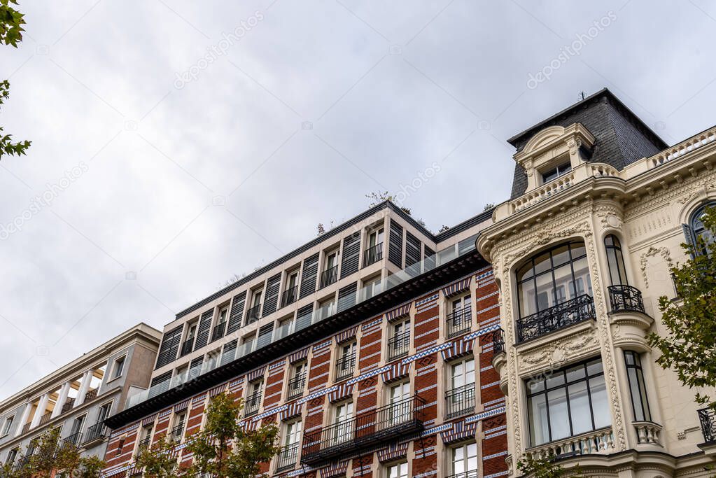 Old luxury residential buildings with balconies in Serrano Street in Salamanca district in Madrid