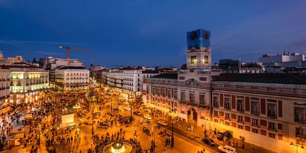 Vista panorámica de la Puerta del Sol en Madrid con una multitud de personas al atardecer —  Fotos de Stock